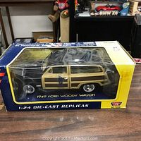 Photo showing 1949 Ford Woody Wagon 1:24 die cast model car inside its original box with Motor Max branding.
