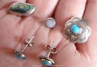 Single turquoise stud earrings and abalone and opal studs are displayed on a palm for scale.