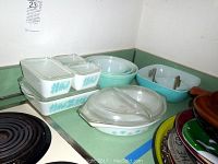Overall view of nesting bowls, refrigerator dishes, divided and square casserole dishes on counter