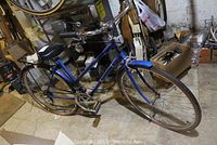 Full side view of blue Brittany Free Spirit Cruiser bicycle with fenders and saddle in basement.