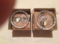 Two Belfor crystal coasters in original boxes, showing starburst cut pattern, scalloped edges, and gold brand stickers.