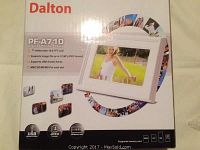 Front of box showing brand Dalton, model PF-A710, and features including 7 inch widescreen 16:9 TFT LCD, support for image files up to 12 MP JPEG, USB thumb drives, and MMC/SD/MS/MS Pro card slots.