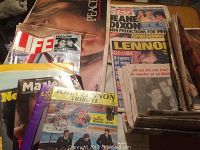 Photo showing a stack of vintage magazines including Life, Star, Globe with covers focused on John Lennon and Beatles