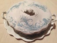 Photo of the covered dish with sculpted handle on lid and scrolling blue floral pattern on white ceramic