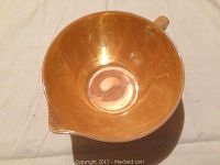 Top-down view of the peach-colored Fire King batter bowl showing the pouring spout and handle.