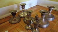 Full set including six pieces: four sterling silver candlesticks, two salt and pepper shakers.