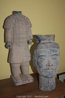 Full view of two sculptures: one head bust and one full warrior figure with armor.