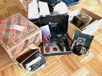 Photo of vintage items including Rolex 3-Minute Masseur in box, GE iron, and I. L. Ruffino wooden box on wooden floor.
