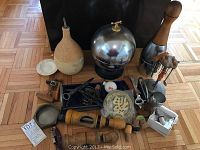 Overview of lot items arranged on floor including dispensers, shaker, ice bucket, shot glass set, coasters, openers and accessories