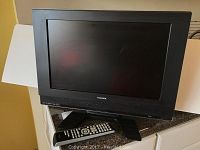 Front view of Toshiba 19 inch LCD TV with screen and base stand.