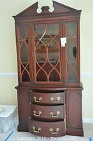 Full front view of wood hutch showing glass-door cabinet and lower drawer unit