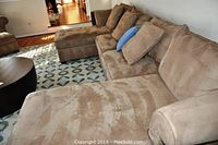 Three-piece sectional sofa with two chaise ends and pillows in living room