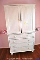 Full front view of wardrobe showing two-door cabinet above and five drawers below