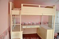 Full assembled loft bed system with ladder left, bed platform top and desk modules below.