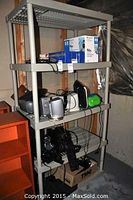 Full view of the grey plastic shelving unit with four shelves shown from slightly different angles.