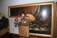 Lot with large framed floral painting, two smaller framed floral prints, flower pot with artificial flowers, and small clock