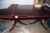 Photo showing full length of cherry dining table with the two leather table pads laid on top, highlighting size and surface condition.