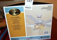 Front side of the boxed Hampton Bay ceiling fan showing brand, model number 337 762, and product features including 52-inch blade span, white finish, frosted white glass bowl, and lifetime motor warranty.