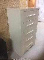 Front view of the vintage painted wood dresser showing five drawers and curved bottom edge.