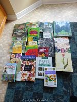 Full overview of 20+ gardening books fanned out on carpet