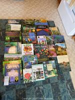 Photo showing all gardening books laid out on the floor, titles very visible.