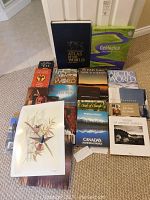 Group image of all books laid on carpet, including large National Geographic Atlas and Geologica boxed set