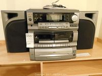 Front view of TEAC stereo system with speakers, showing all control buttons and remote on top.