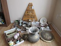 Photo showing entire lot including wooden rack with souvenir spoons, assorted glasses, tea cups, candle holders, and metal trays