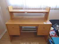 Full view of the wood desk showing the 4 drawers, removable top rack, and overall structure.