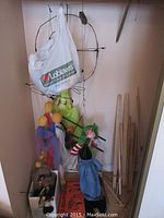 Wide view of marionette making lot showing several puppets, puppeteer controls, wooden sticks, and a plastic bag containing items