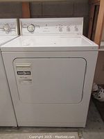 Full view of Kenmore white clothes dryer showing front door and top control panel area.