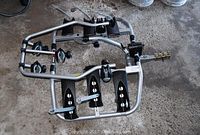 Top view of the 3-bike carrier showing the wheel trays and attachment mechanisms