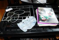 Photo showing stained glass pieces including a large 12x18 panel, a unicorn 9x6 hanging, three small glass hangers, and three stained glass pattern books.