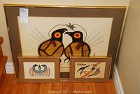 Three framed prints by Jackson Beardy arranged on floor showing sizes and motifs