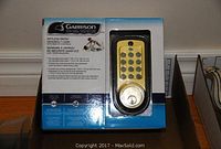 Full view of new Garrison keyless entry deadbolt lock in original box showing brand, product and keypad.
