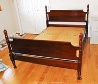 Full view of Gibbard double bed frame showing headboard, footboard, and base with wood slats and metal supports on a wooden floor.