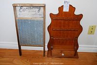 Overall photo showing both the Economy zinc washboard and wooden spoon rack with drawer side by side on a hardwood floor against a white wall.