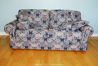 Front view of the La-Z-Boy hideabed sofa with floral upholstery and accent pillows.