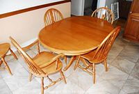 Full view of round dining table and all five Windsor style chairs