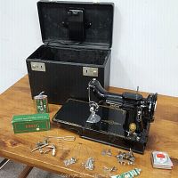 Full lot overview showing sewing machine, case, oil can, accessory box, attachments, tape measure, and keys