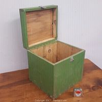 Open vintage wooden tool box showing interior unfinished wood and green painted exterior.