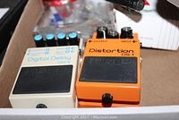 Photo of Boss DD-6 Digital Delay and DS-1 Distortion pedals side by side showing model and brand details.