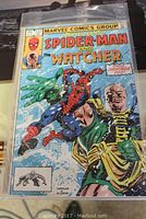 Cover image of Marvel Team-Up Spider-Man and The Watcher, issue #127, featuring Spider-Man fighting a large foe with The Watcher in the background, protected in a plastic sleeve.