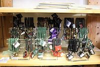 Wide shot of lucite stands with various stone bead bracelets