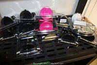 Various Tech360 Quick-Snap Mount Technology holders in original packaging in colors black, pink, blue, and white on display.