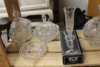 Photo showing 3 lidded decorative containers, a crystal bowl, candleholder, and new Royal Crystal vase in box.