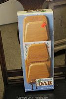 Oak letter rack in original box photographed on chair