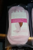 Close-up of single pink Blissful Moisturizing Gel Sock in original packaging showing moisturizing oil benefits and grip dots on sole.