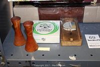 Wooden decorative salt and pepper shakers, coaster set box, and vintage wooden slicer box on metal shelving