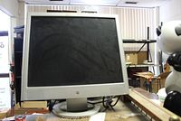 HP VS19e computer monitor powered off with black screen on a desk.